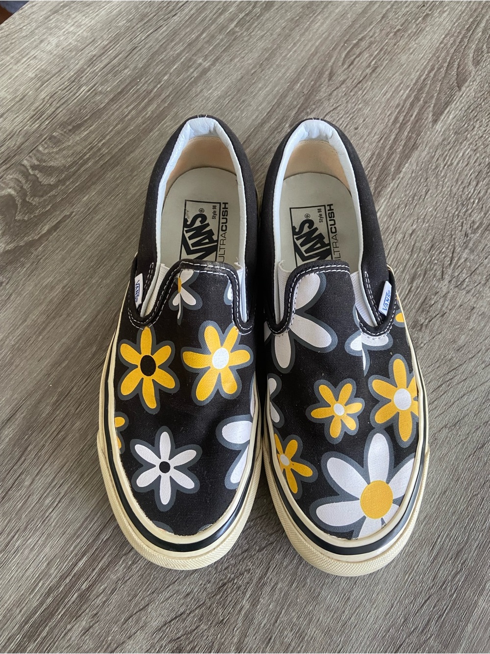 Vans Slip-On Sneakers in Black with Yellow Daisy Print